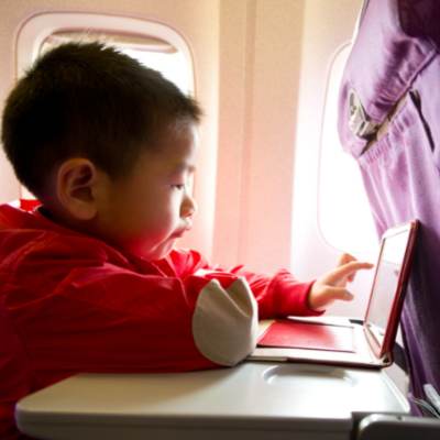 Child is being entertained during a boring flight